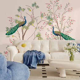 Cozy reading nook wallpaper in soft blush tones with floral branches and detailed peacock artwork