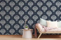 Navy damask wallpaper with bold white ornamental pattern elevates modern living room decor