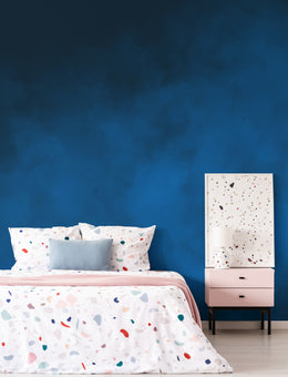 Sophisticated guest room accent wall with dark blue artistic texture, creating a calm inviting atmosphere