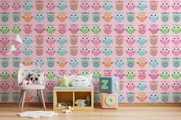 Playful playroom accent wall wallpaper featuring colorful owl cartoon pattern in pastel shades, perfect for kids space