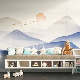 Playful blue mountain mural with bright birds, perfect for inspiring kids’ room walls.