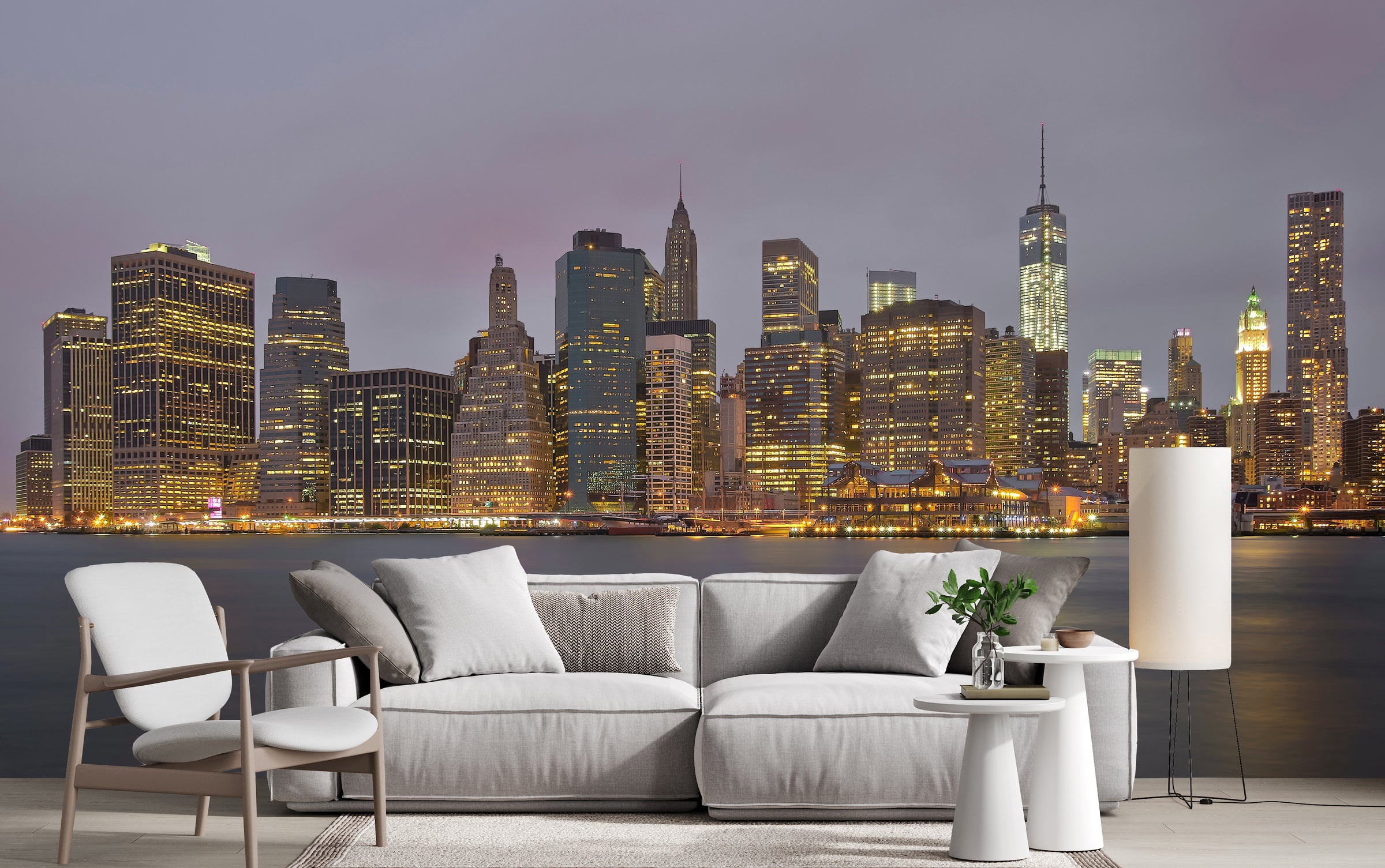 Elegant living room with panoramic night skyline wall mural overlooking illuminated skyscrapers across calm waterfront.
