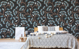 Elegant bedroom accent wall featuring black background blue leaf botanical pattern, cozy interior styling