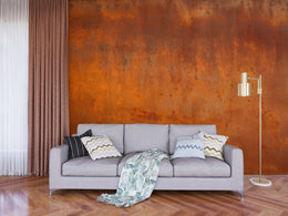 Modern workspace accent wall featuring industrial rust texture in deep orange color tones