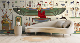 Egyptian wallpaper featuring ancient hieroglyphics and winged goddess artwork, beige living room accent wall